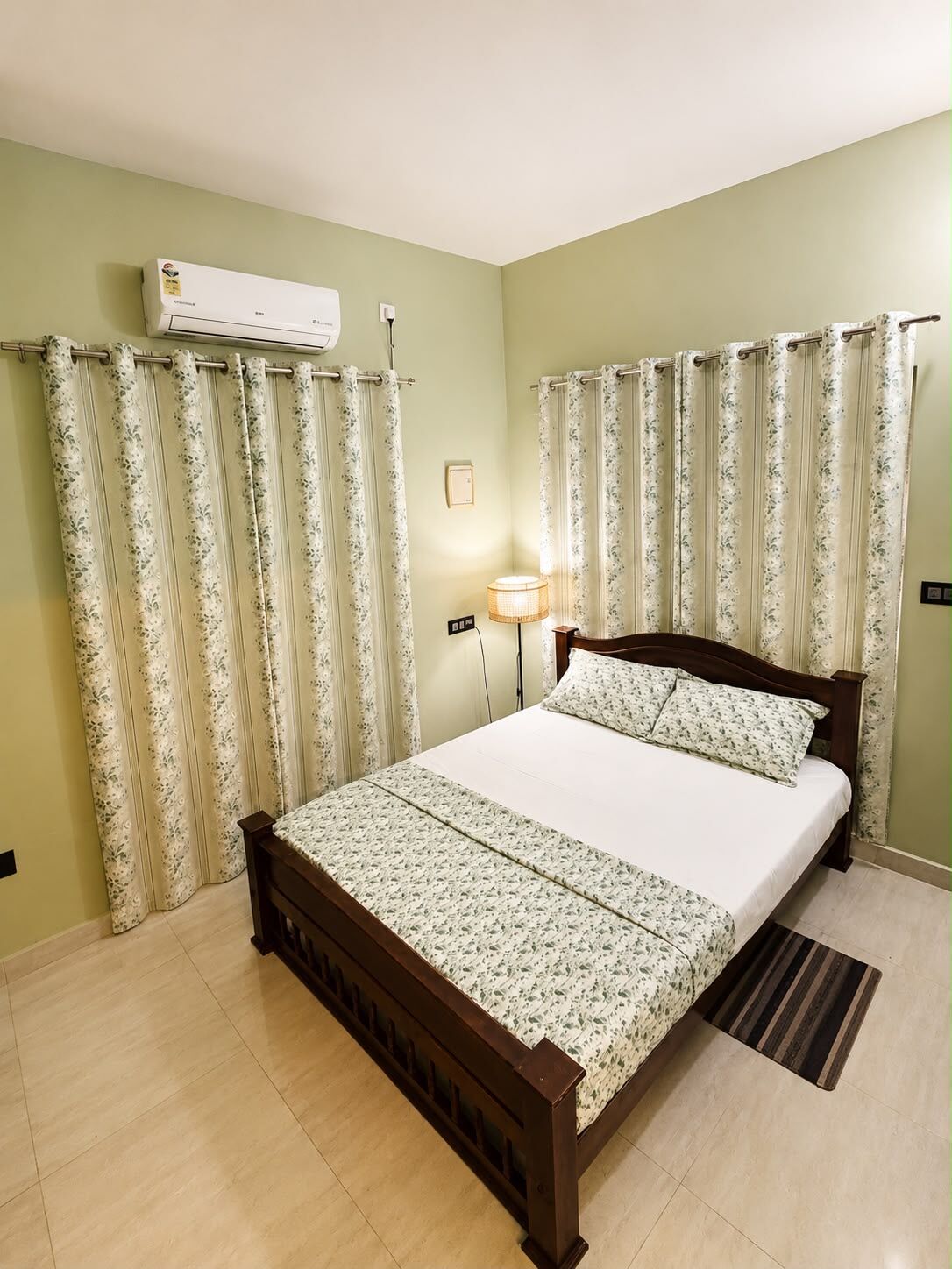 Sage-green suite bedroom at The Shore Wellness